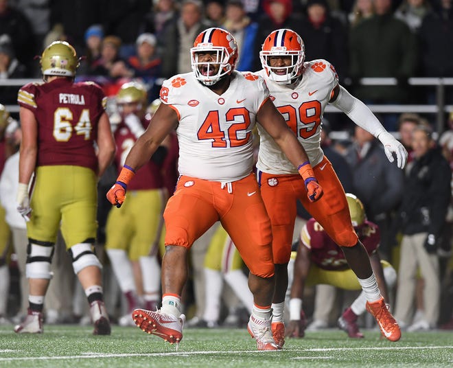 Clemson defensive lineman Christian Wilkins (42) celebrates with defensive lineman Clelin Ferrell (99) after bringing down Boston College quarterback Anthony Brown (13) during the 1st quarter at Boston College's Alumni Stadium in Chestnut Hill, MA. Saturday, November 10, 2018.