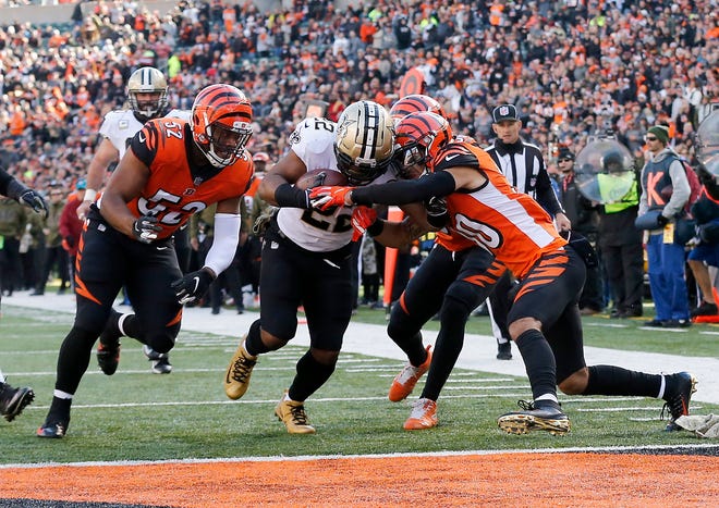 New Orleans Saints running back Mark Ingram (22) pushes through a group of Bengals defenders for a touchdown in the second quarter of the NFL Week 10 game between the Cincinnati Bengals and the New Orleans Saints at Paul Brown Stadium in downtown Cincinnati on Sunday, Nov. 11, 2018. The Saints led 35-7 at halftime. 
