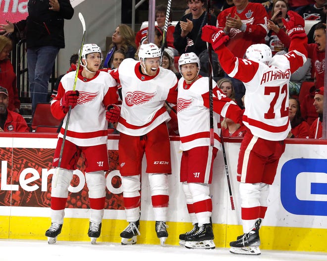 Detroit Red Wings' Anthony Mantha (39) celebrates his goal with teammates Dennis Cholowski (21), Gustav Nyquist, and Andreas Athanasiou (72) during the third period.