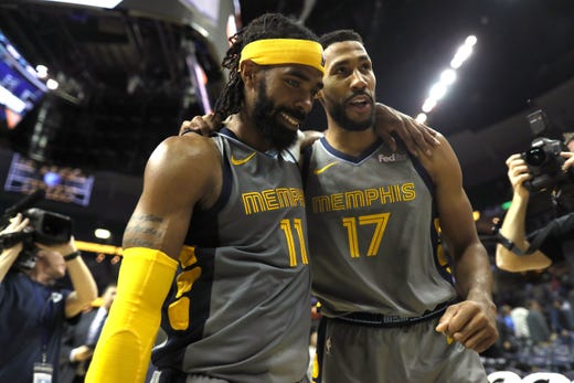 Memphis Grizzlies guard Mike Conley, left, and Garrett Temple walk off the court after beating the Philadelphia 76ers in overtime 112-106 at the FedExForum on Saturday, November 10, 2018.