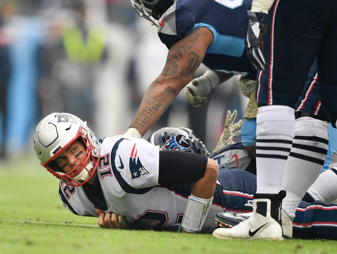 Patriots quarterback Tom Brady (12) after another sack in the second quarter Sunday.