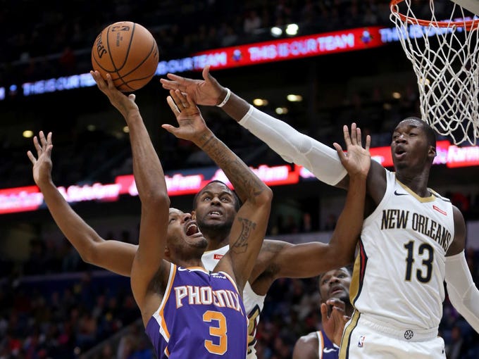 Nov 10, 2018; New Orleans, LA, USA; Phoenix Suns forward Trevor Ariza (3) is defended by New Orleans Pelicans forwards Darius Miller (21) and Cheick Diallo (13) in the first quarter at the Smoothie King Center. Mandatory Credit: Chuck Cook-USA TODAY Sports