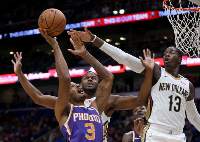 Nov 10, 2018; New Orleans, LA, USA; Phoenix Suns forward Trevor Ariza (3) is defended by New Orleans Pelicans forwards Darius Miller (21) and Cheick Diallo (13) in the first quarter at the Smoothie King Center. Mandatory Credit: Chuck Cook-USA TODAY Sports