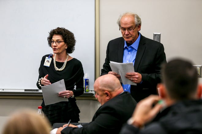 Vicki Lake, left, and Hal Crocker, right, present their plans for a new school during a special session of the county commission meeting to vote on the funding for a new school at West Tennessee AgResearch Center in Jackson, Tenn., on Monday, Nov. 12, 2018.