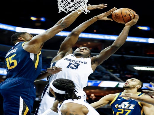 Memphis Grizzlies forward Jaren Jackson Jr. (middle) goes up for a put back layup against Utah Jazz defenders Derrick Favors (left) and Rudy Gobert (right) during action at the FedExForum in Memphis, Tenn., Monday, November 12, 2018.