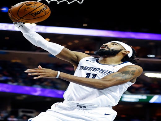 Memphis Grizzlies guard Mike Conley drives for a layup against the Utah Jazz defense during action at the FedExForum in Memphis, Tenn., Monday, November 12, 2018.