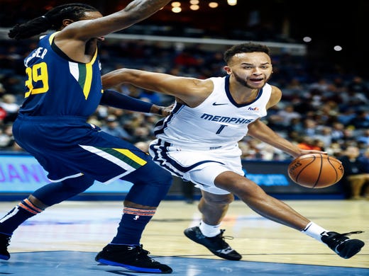 Memphis Grizzlies forward Kyle Anderson (right) drives the lane against Utah Jazz defender Jae Crowder (left) during action at the FedExForum in Memphis, Tenn., Monday, November 12, 2018.