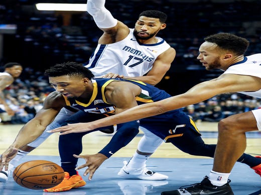 Memphis Grizzlies teammeats Garrett Temple (left) and Kyle Anderson (right) apply defensive pressure to Utah Jazz guard Donovan Mitchell (middle) during action at the FedExForum in Memphis, Tenn., Monday, November 12, 2018.