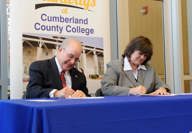 Harvey Kesselman, Ed.D., Stockton University President and Shelly O. Schneider, Ed.D., Cumberland County College Interim President sign a dual admission and transfer agreement at Cumberland County College on Tuesday, November 13, 2018. 