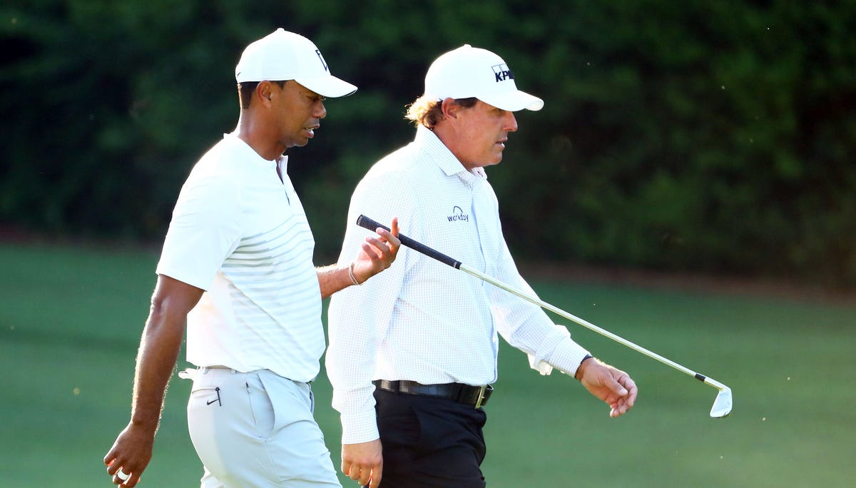 Tiger Woods and Phil Mickelson walk down the 11th fairway during a practice round for the Masters at Augusta National on April 3.
