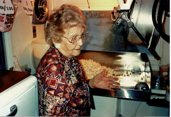 After selling her popcorn stand to the Bob Wendt and his sons Russ and Gary, Agatha Straub demonstrates methods used to make her tasty popcorn.