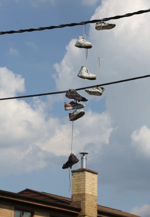 Maj. William Hibbs, of the 9th Mobile police unit, often drives past scenes such as this one in the Park Hill neighborhood.  Residents offer a variety of reasons that shoes hang from utility lines, but Hibbs believes that it is a sign that drugs are available in the area. Sep. 19, 2018