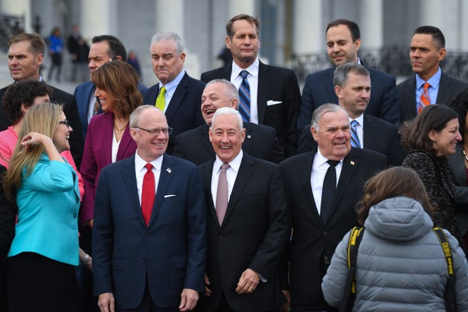 Greg Pence, R-IN, front center right, and John Rose, R-TN, front center left, along with Jim Baird, R-IN, front right, and the other newly-elected House Members of the 116th Congress gather at the U.S. Capitol for a class photo, Wednesday, Nov. 14, 2018, in Washington.
