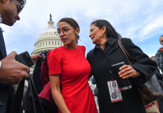 Newly-elected House Members Alexandria Ocasio-Cortez, D-NY, left, and Deb Haaland, D-NM, depart following a class photo outside of the U.S. Capitol, Wednesday, Nov. 14, 2018, in Washington.
