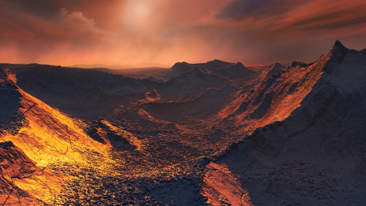 An artist's impression of the surface of the planet that's orbiting Barnard's Star, the nearest single star to the sun. Data from a worldwide array of telescopes have revealed this frozen, dimly lit world.