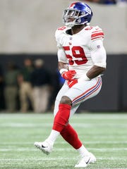 Oct 22, 2018; Atlanta, GA, USA; New York Giants linebacker Lorenzo Carter (59) celebrates after a sack against the Atlanta Falcons in the first quarter at Mercedes-Benz Stadium.