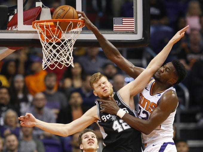 Phoenix Suns center Deandre Ayton (22) is fouled by San Antonio Spurs forward Davis Bertans (42) while making a basket during a NBA game at Talking Stick Arena in Phoenix on November 14.