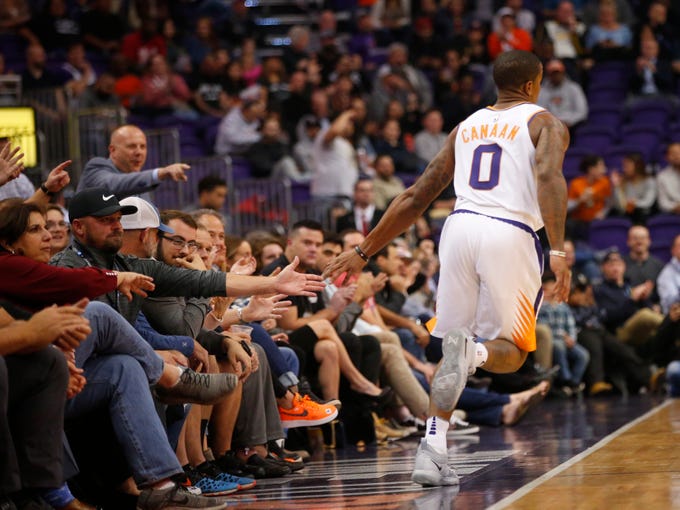 Phoenix Suns guard Isaiah Canaan (0) high fives the fans after shooting a 3-point shot during a NBA game against the San Antonio Spurs at Talking Stick Arena in Phoenix on November 14.  
