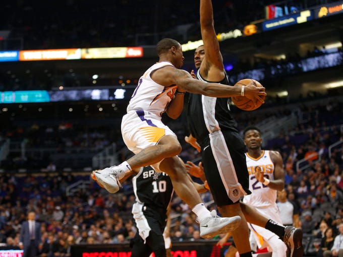 Phoenix Suns guard Isaiah Canaan (0) passes the ball around San Antonio Spurs forward LaMarcus Aldridge (12) during a NBA game at Talking Stick Arena in Phoenix on November 14.  