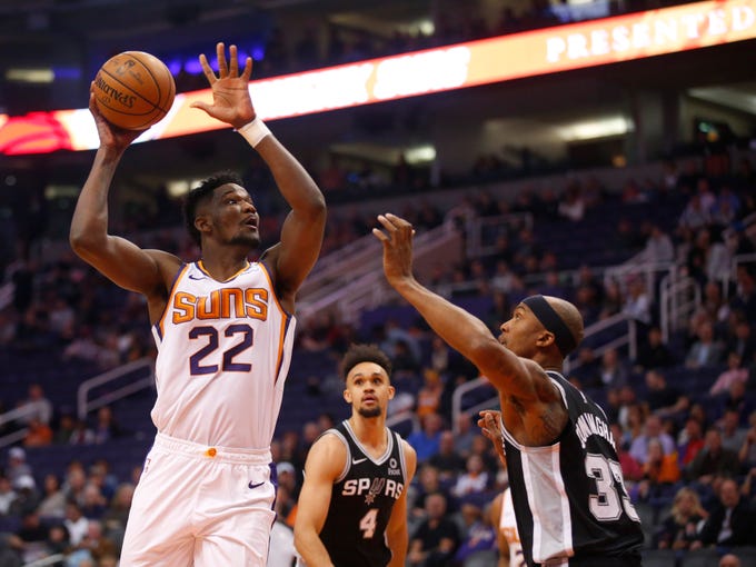 Phoenix Suns center Deandre Ayton (22) looks to shoot while being guarded by San Antonio Spurs forward Dante Cunningham (33) during a NBA game at Talking Stick Arena in Phoenix on November 14.