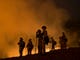 Firefighters hold a line in the Camp Fire with a control burn Near Bloomer Hill in Butte County in California on Nov. 14, 2018. 