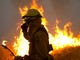 Firefighters hold a line in the Camp Fire with a control burn Near Bloomer Hill in Butte County in California on Nov. 14, 2018. 