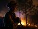Firefighter Dylan Foster helps hold a line in the Camp Fire with a control burn Near Bloomer Hill in Butte County in California on Nov. 14, 2018. 