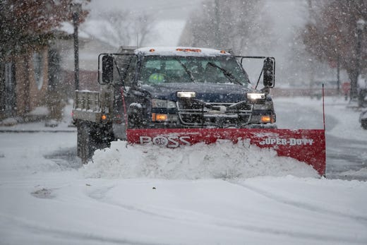 A snow truck clears snow in the parking lot of the Hockessin Fire Hall. 