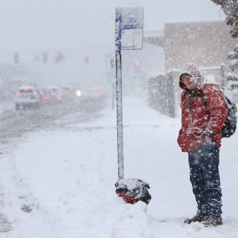 Lyod Graham waits for the bus during a snowstorm...