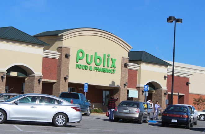 Shoppers greet each other outside the Publix grocery store on Madison Street in south Clarksville.