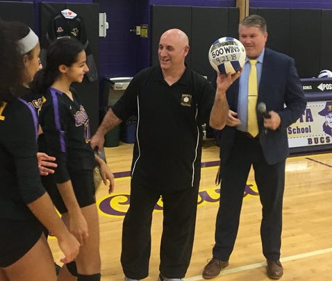 Bogota girls volleyball coach Brad DiRupo with the game ball from his 500th career win, after superintendent Damien Kennedy (right) made the formal presentation on Nov. 7, 2018.