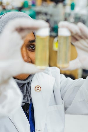 Naima Khan, who received her MS and Ph.D. in water science and management with Kenneth "KC" Carroll, can be seen inspecting experimental water samples in the lab where she does chemical analysis including mass spectrometry to determine if ozone has reacted with organic contaminants in water.