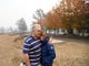 Rhys and Valerie Owen of Paradise, California, stand in the front yard of their home, which narrowly escaped the Camp Fire. Flames spared little on the property, but the home, barn and chicken coop are still standing.