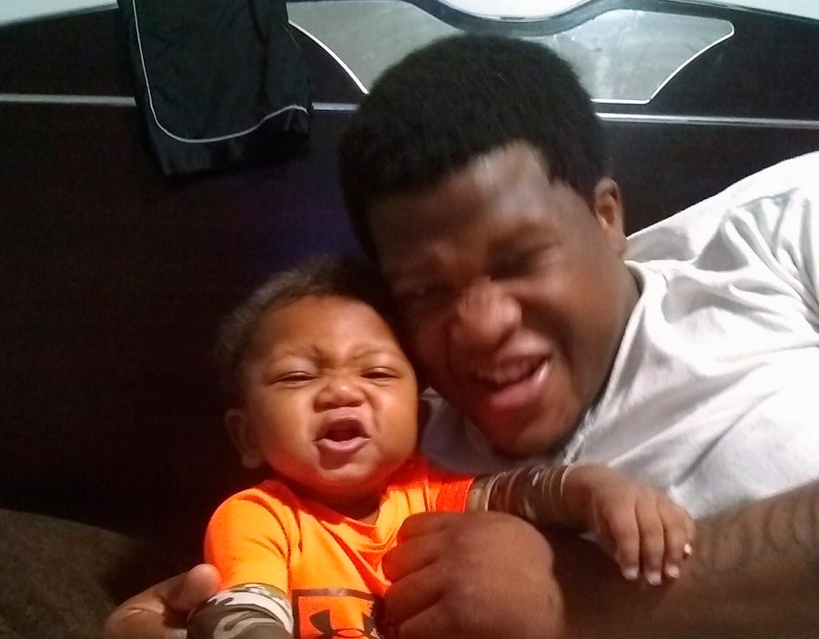 This photo provided by Avontea Boose shows her baby Tristan Roberson and the boy's father Jemel Roberson. A police officer fatally shot Jemel Roberson, as he was holding a man down following a shooting inside a suburban Chicago bar where the guard worked.