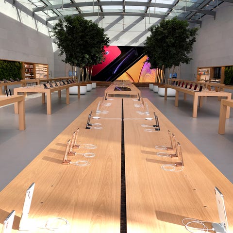 Rows of iPhones in the remodeled Apple Store in...