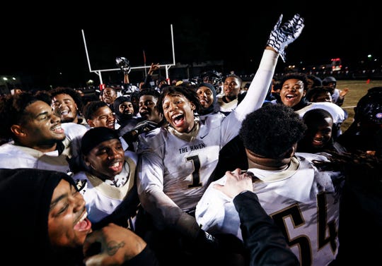 Whitehaven's Bryson Eason (middle) celebrates with his teammates after defeating Germantown 14-0 during their 6A state playoff game in Germantown, Tenn.