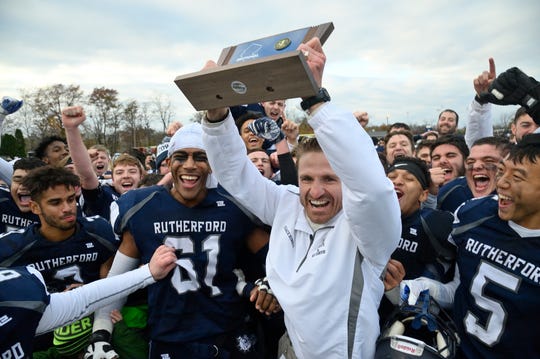 Rutherford coach Andrew Howell celebrates the win with his team in the  North 2, Group 2 football championship game against Lyndhurst in Rutherford.