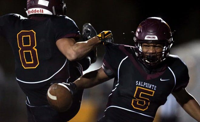 Lathan Ransom and Bijan Robinson celebrate during Salpointe Catholic’s 53-6 semifinal win over Sahuaro at Mountain View High School on Friday, Nov. 16, 2018.