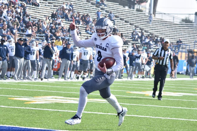 Nevada's Ty Gangi scores just before halftime on Saturday.