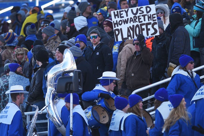 SDSU fans hold a sign that reads, "Hey USD how are the playoffs" during the game Saturday, Nov. 17, at Dana Dykhouse Stadium stadium in Brookings.