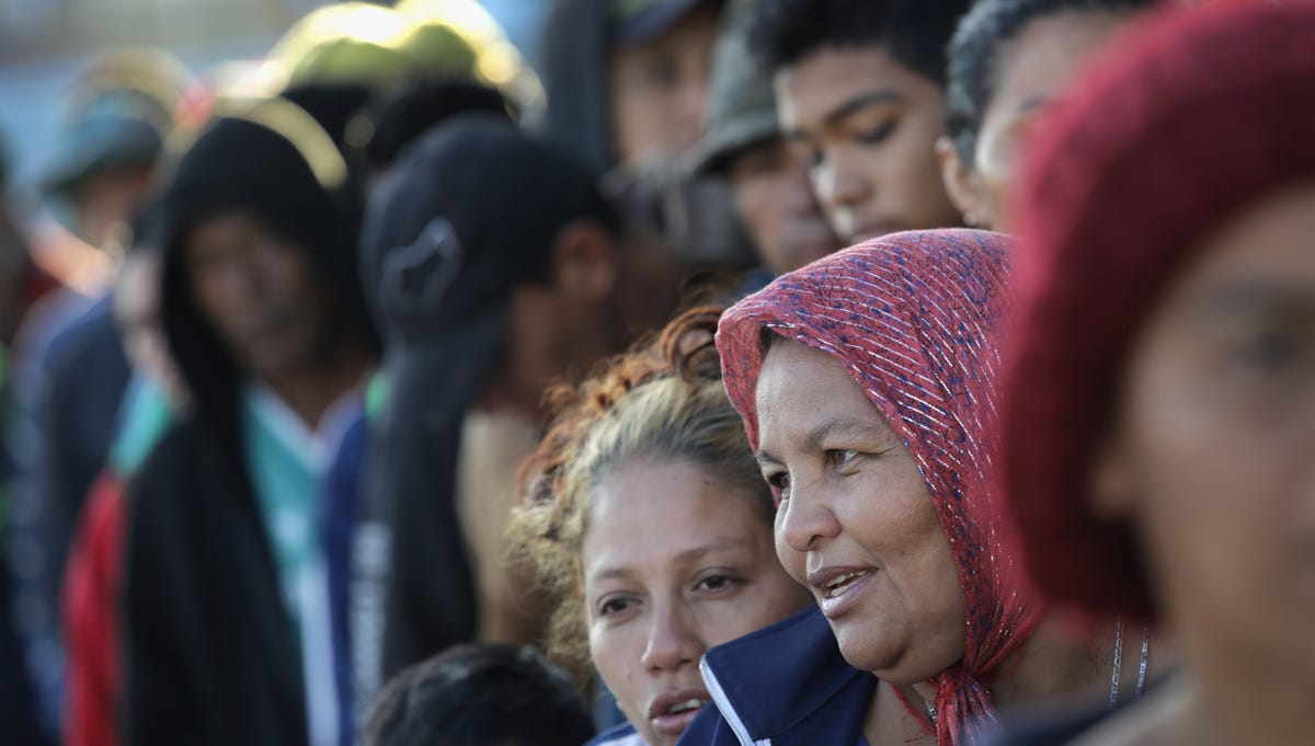 Members of the migrant caravan wait in line to turn in requests for political asylum at the U.S.-Mexico border on Nov. 17, 2018 in Tijuana, Mexico. 