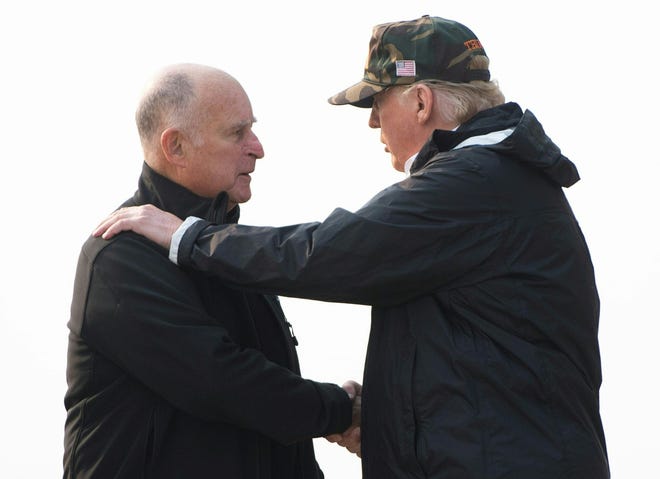 President Donald Trump, right, greets California Gov. Jerry Brown as he arrives Nov. 17, 2018, at Beale Air Force Base in California