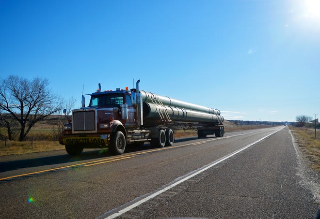 Semi-trailer truck loaded with 36-inch pipe for the Keystone XL Pipeline heads west on U.S. Highway 2 between Hinsdale and Glasgow, Mont., en route to a pipe yard in northern Phillips County.