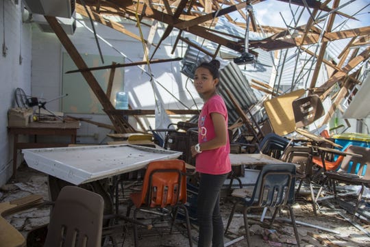 A sixth grader at Hopwood Middle School visits her mathematics classroom after Super Typhoon Yutu made landfall, severely damaging the school. The school is temporarily closed as the village works together with the Commonwealth, voluntary organizations, and federal agencies to cleanup and restore the classrooms.