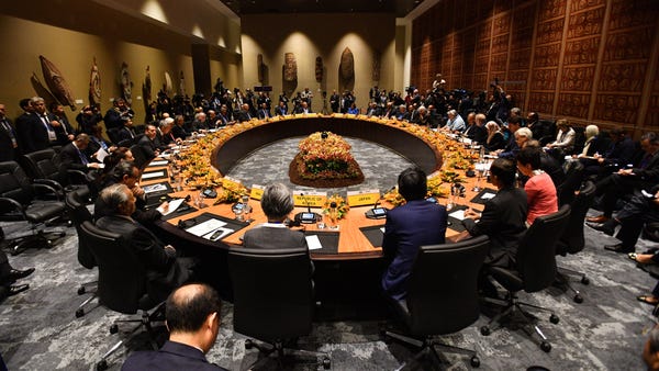 Leaders sit at a round table for the APEC...