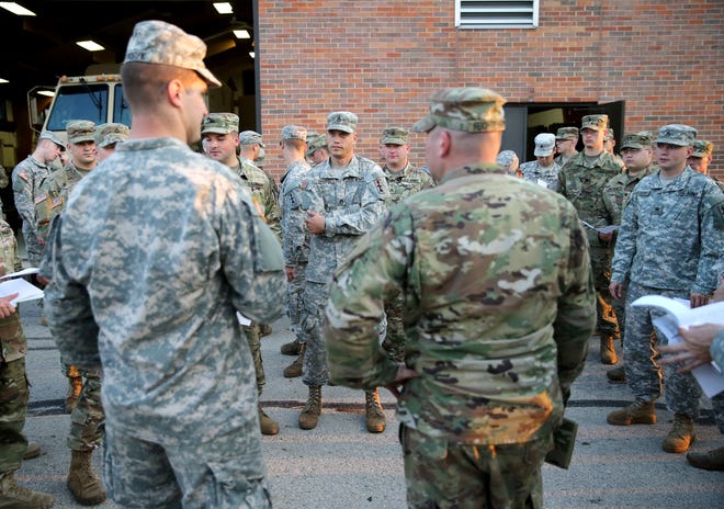 Members of the Headquarters and Headquarters Company, 2nd battalion, 127th Infantry, of the Wisconsin National Guard gather for a convoy briefing before deployment to Florida to support Hurricane Irma relief efforts Tuesday, Sept. 12, 2017, in Appleton, Wis.