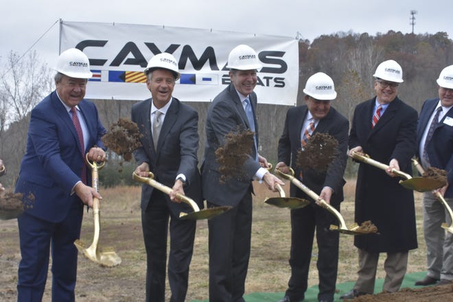 Officials toss dirt at the groundbreaking for Caymas Boats on Monday, Nov. 19 in Ashland City.