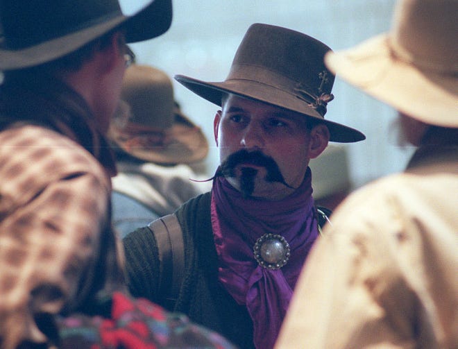 Cowboy Poetry participant Rod Taylor, center, from Oregon, talks to fellow poetry lovers during the 2000 Cowboy Poetry gathering in Elko.