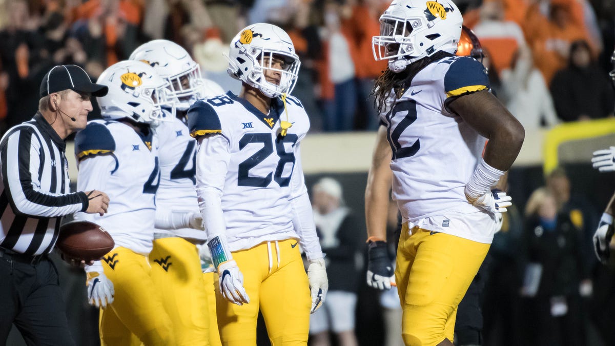 West Virginia players react after a touchdown by Oklahoma State in the fourth quarter at Boone Pickens Stadium.
