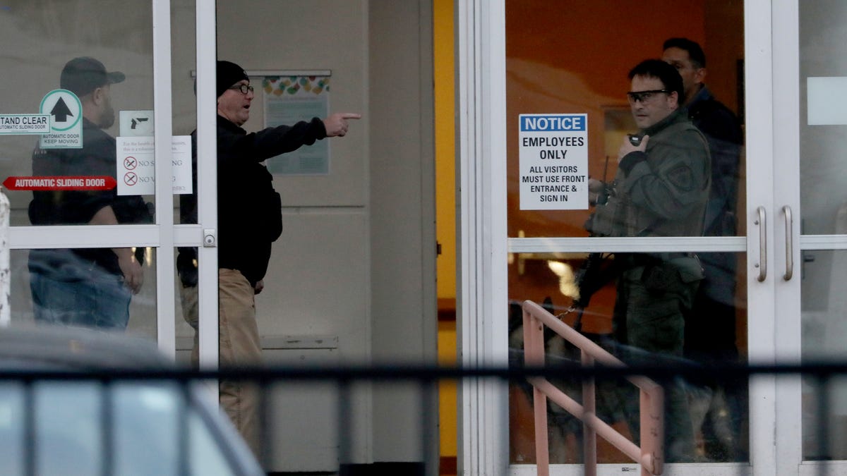 Law enforcement officers including Chicago SWAT work an entrance at Mercy Hospital on Nov. 19, 2018, in Chicago.